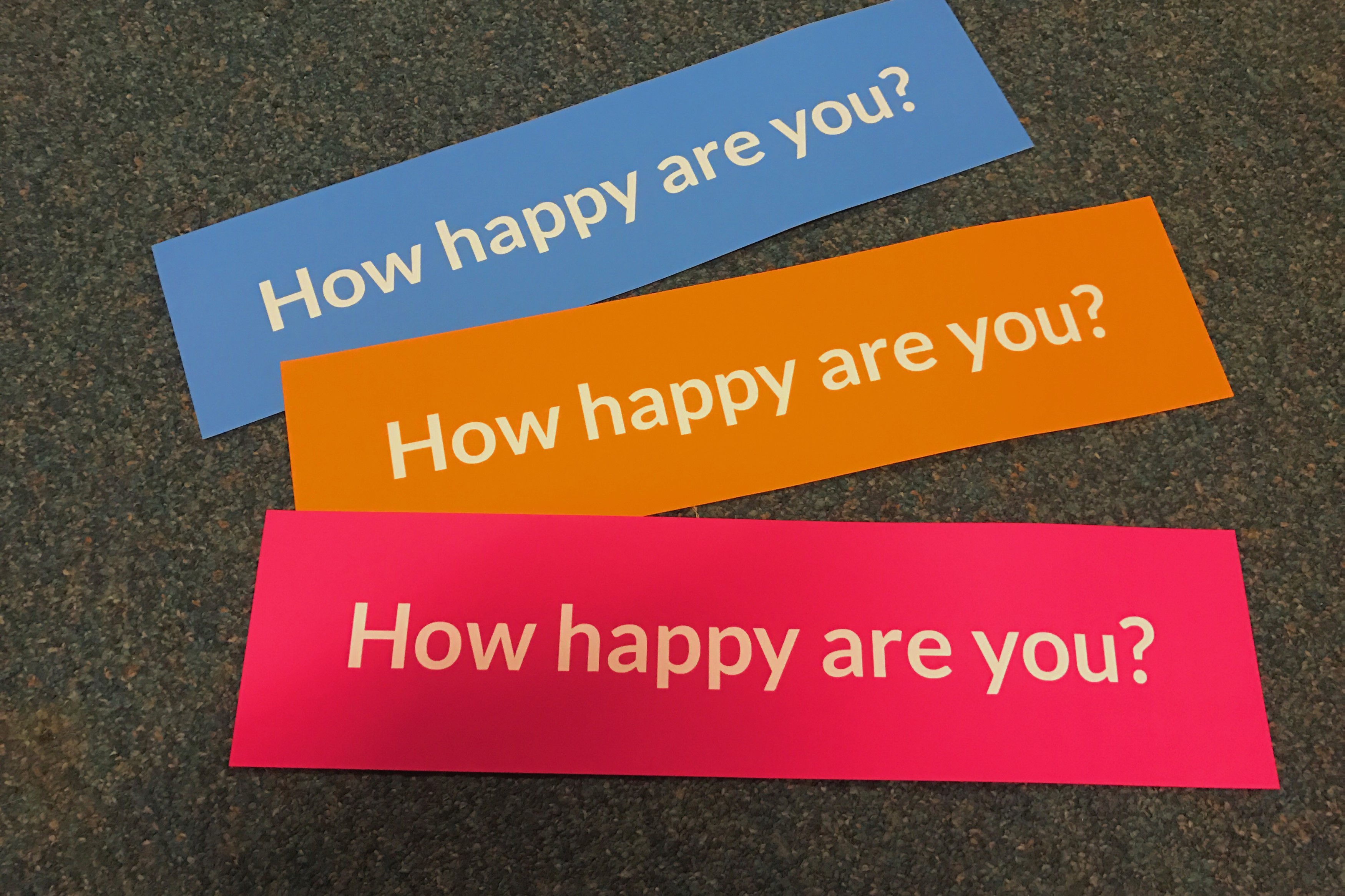 3 signs of different colors with the text "How happy are you?"