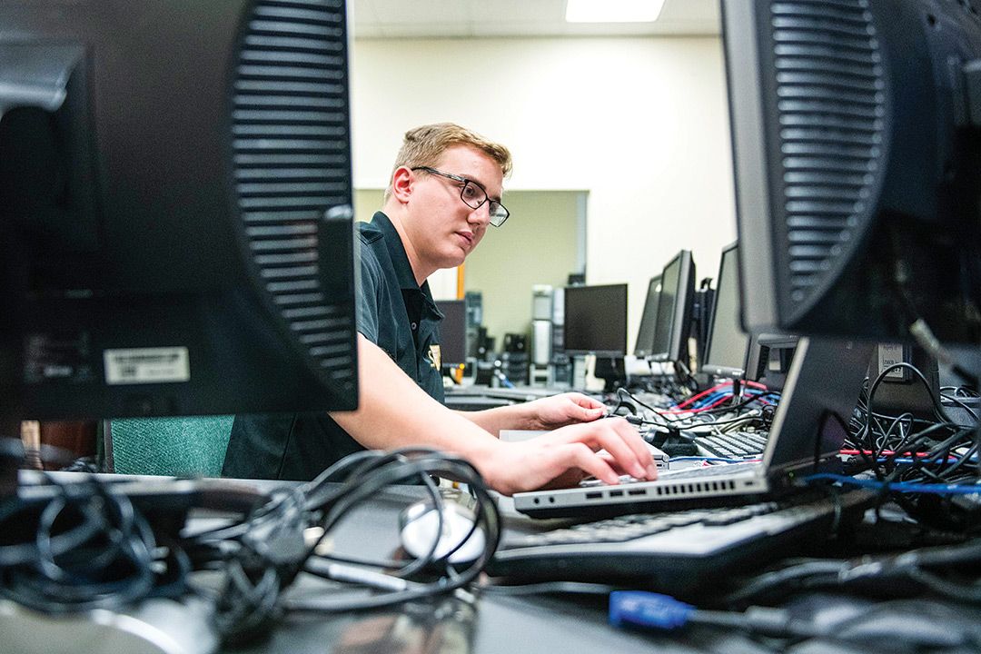 Student works on multiple computers.