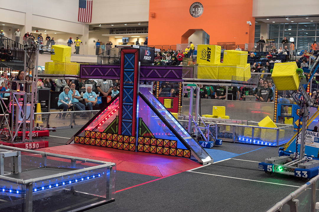 Colorful obstacle course for small, student-created robots holding yellow cubes