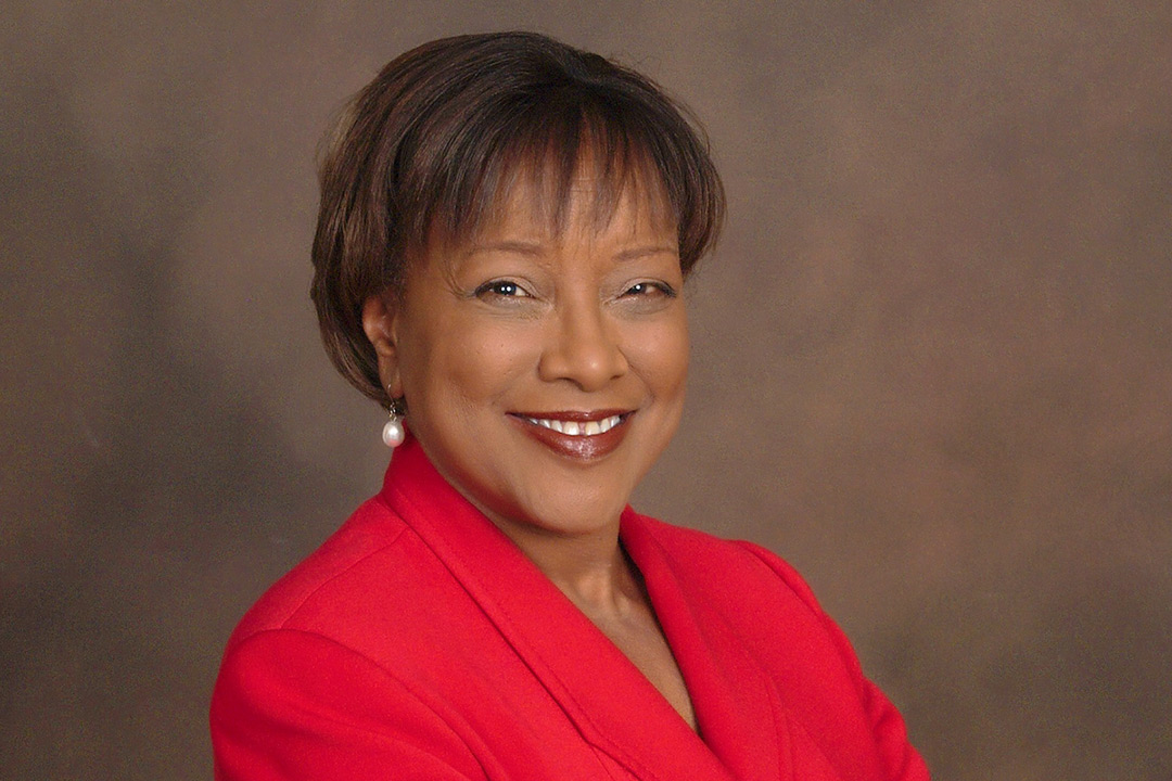 Head-and-shoulders view of woman wearing red blazer