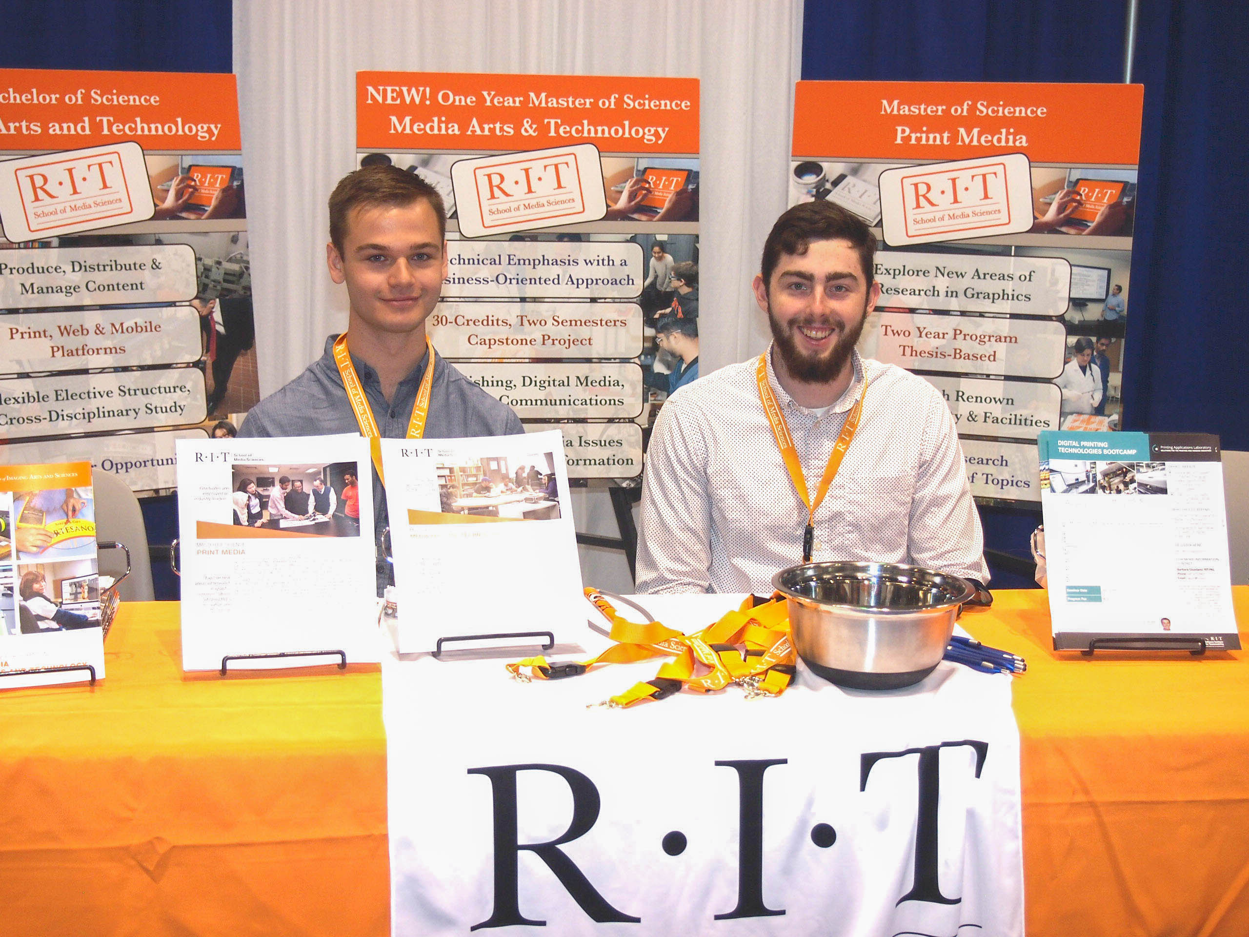 Photo by Bruce Myers: School of Media Sciences students Alexander Greenhalgh, left, and Tommy Hodgson work RIT's booth at Print 17.