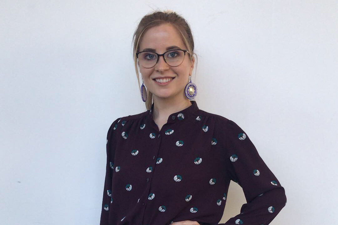 Head-and-shoulders view of student wearing glasses and purple blouse