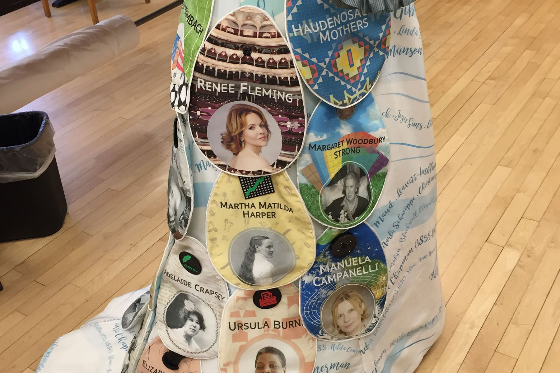 A 3D printed dress with names and images of famous women from Rochester.