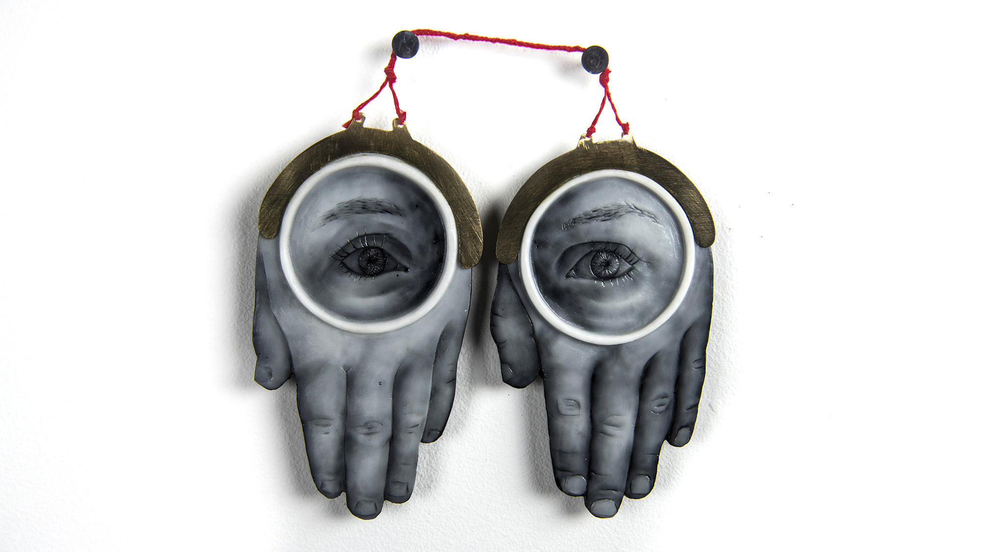 A sculpture of two hands with eyes on them.
