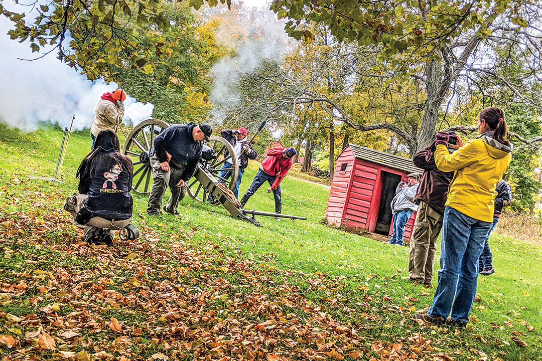 Students take measures as Civil War-era cannon is discharged.