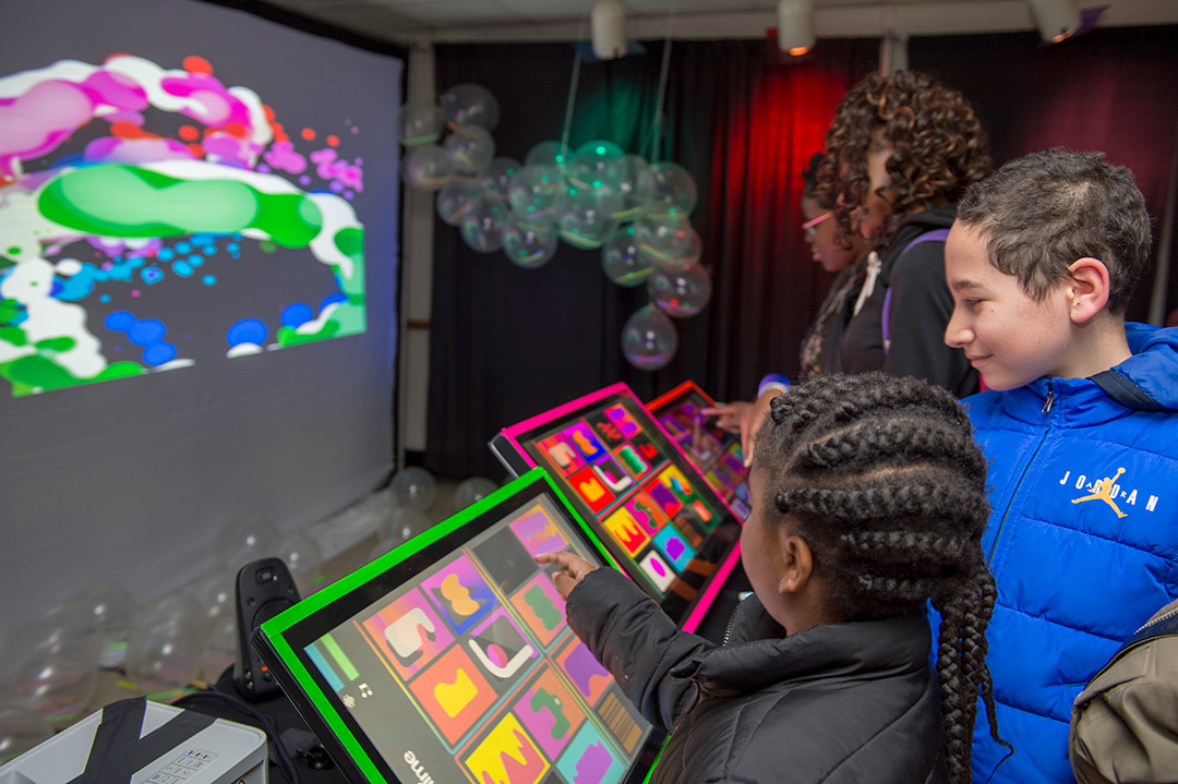 Students use colorful touchscreens.