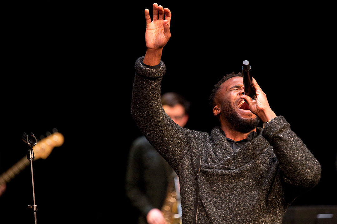 Man sings with microphone.