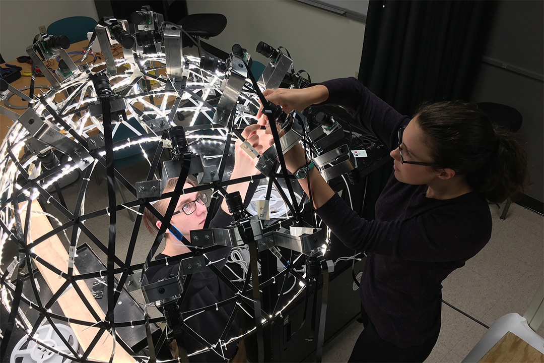 Students work on dome-shaped imaging system.