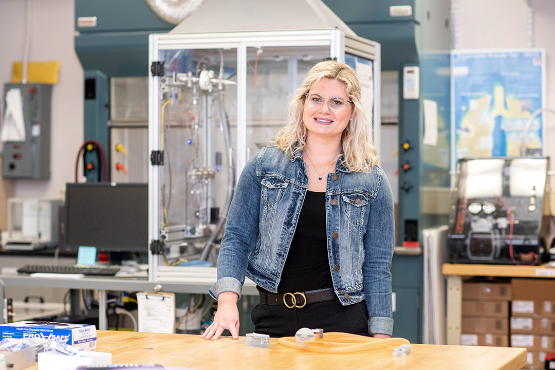 Female student poses in lab.