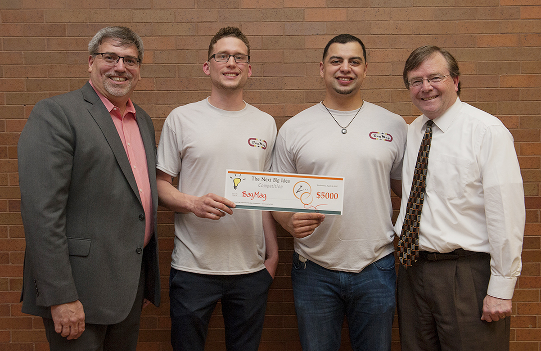 From left to right — Chris Wagner, ZVRS vice president of customer experience and RIT/NTID alumnus and Foundation Board chair; Wade Kellard and Hans Kohls, RIT/NTID students and creators of BAGMAG; and Gerry Buckley, NTID president and RIT vice president and dean, at the Next Big Idea competition.