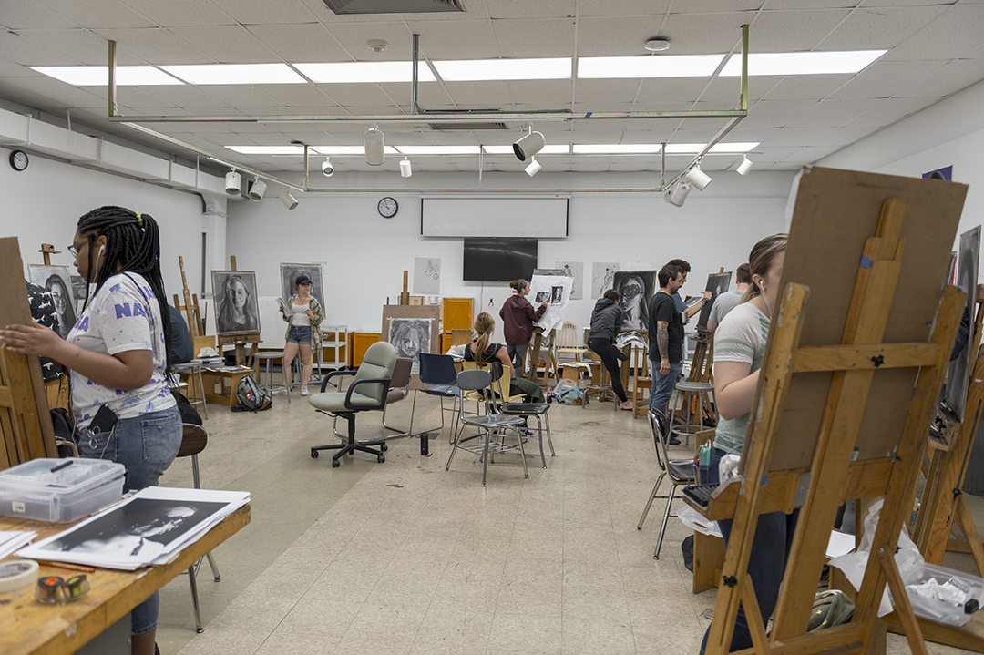 High school students work in an RIT painting studio