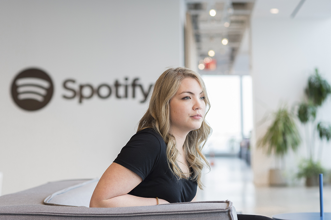 Emmi Hintz sits in a lobby of Spotify's New York City office