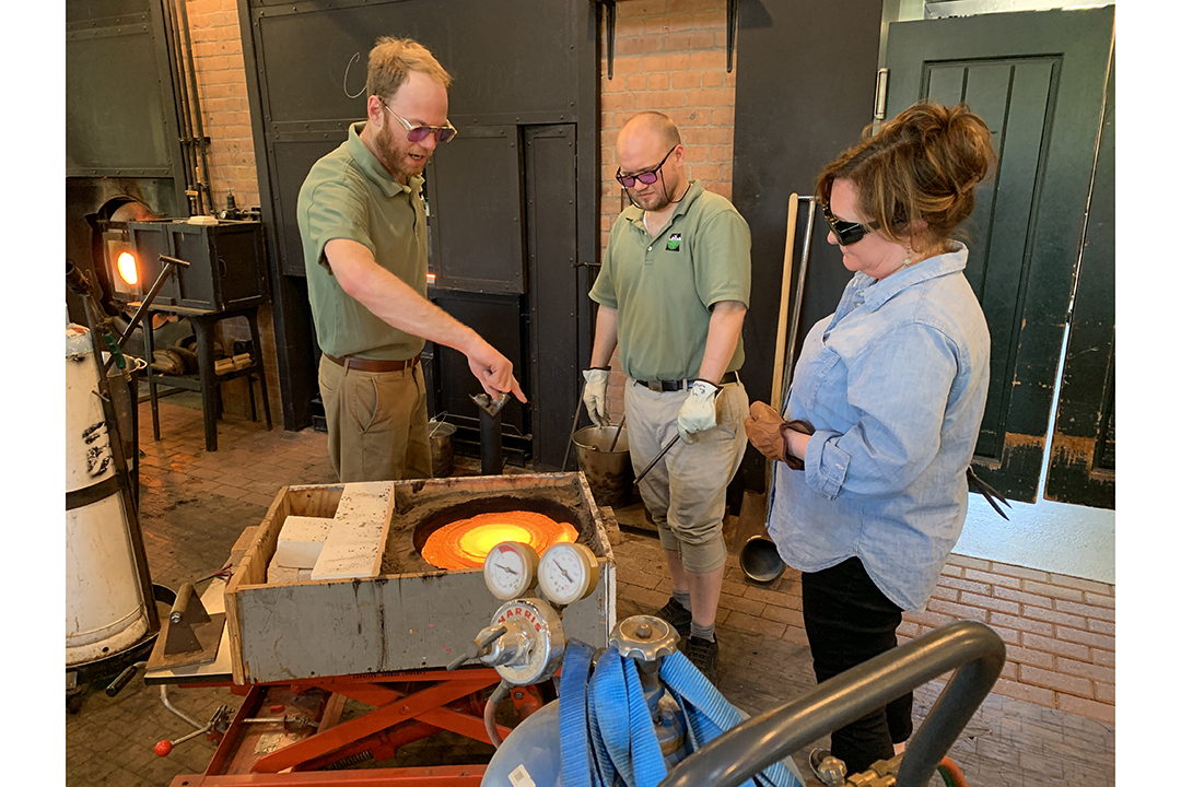 Three glassblowers — including Andy Koupal and Robin Cass — work at the Henry Ford Museum.