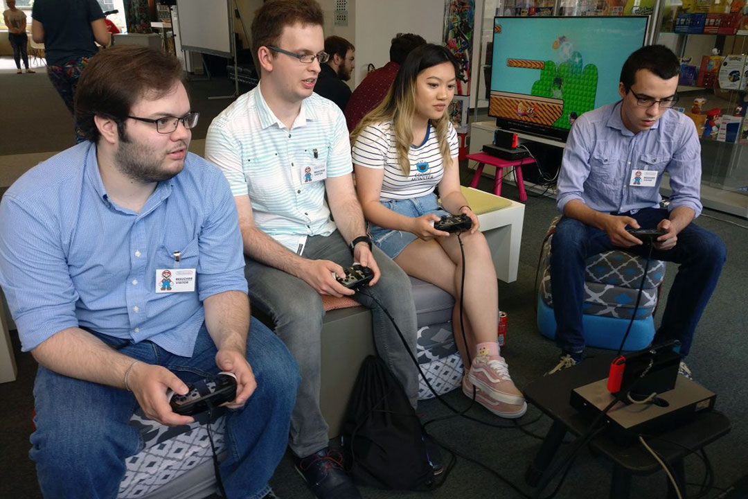 Four students play Nintendo.