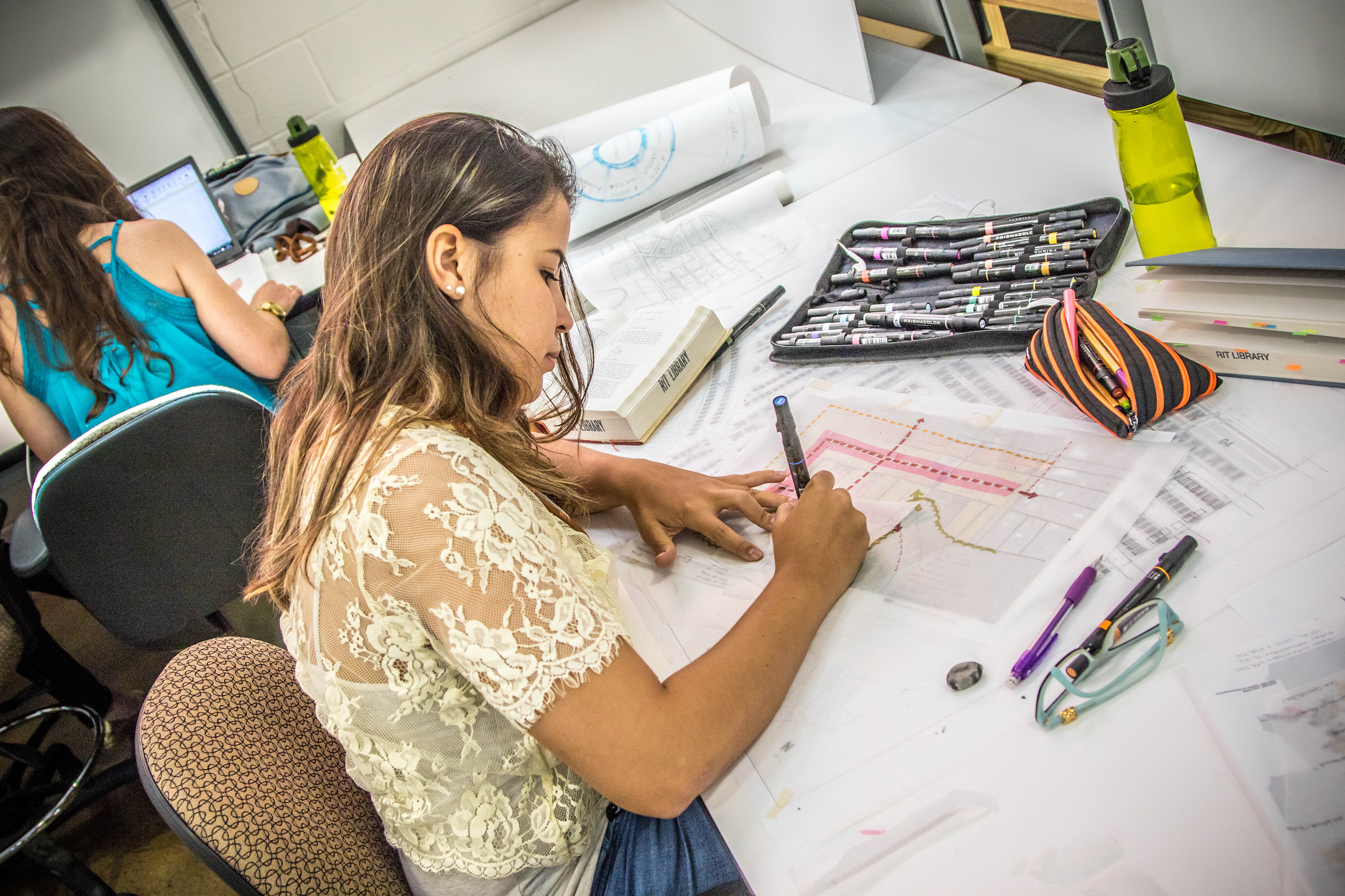 female student working on architectural sketch