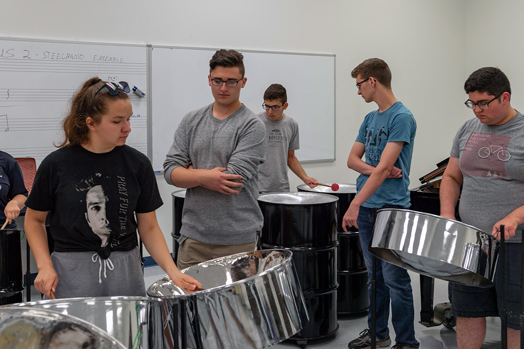 Students play steel drums.