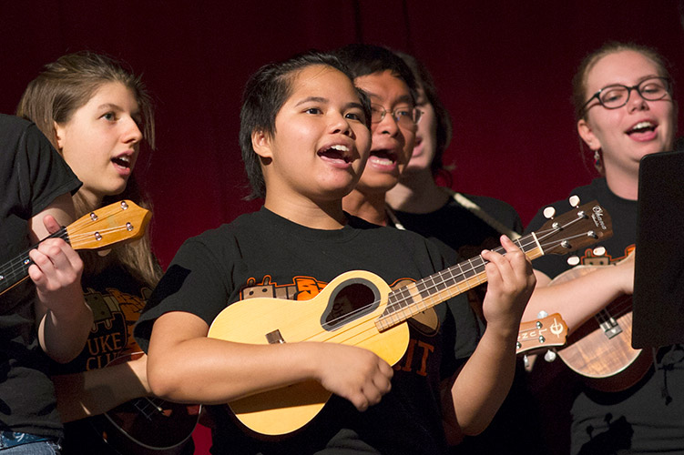 Students sing and play ukuleles.