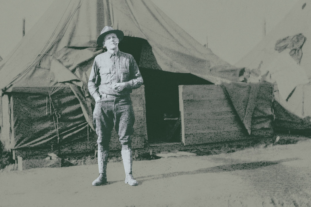 Soldier stands in front of tent in 1917.