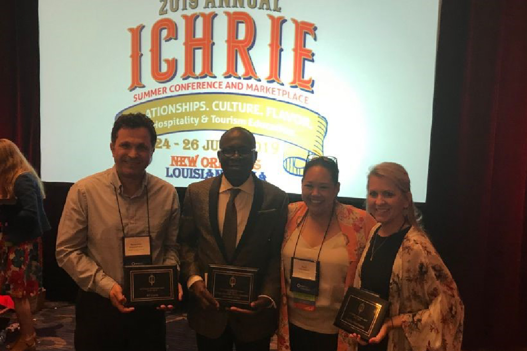 Dr. Muhammet Kesgin accepts ESD Chapter of Distinction Award at the summer ICHRIE conference.