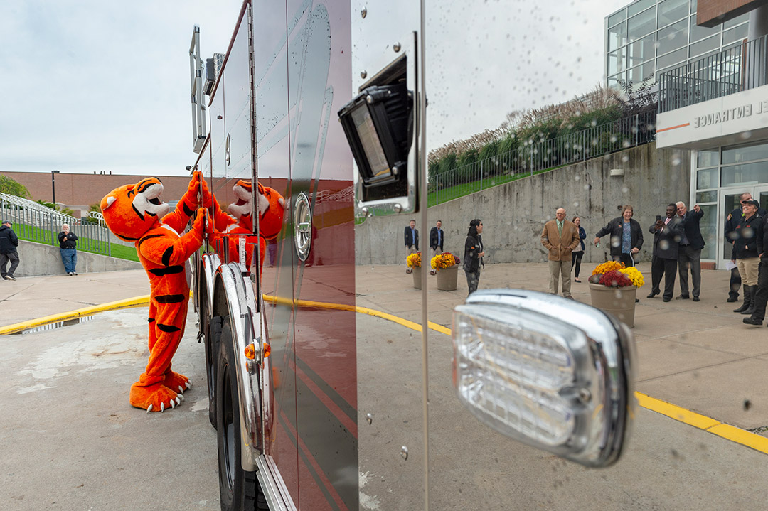 Tiger mascot looks at firetruck