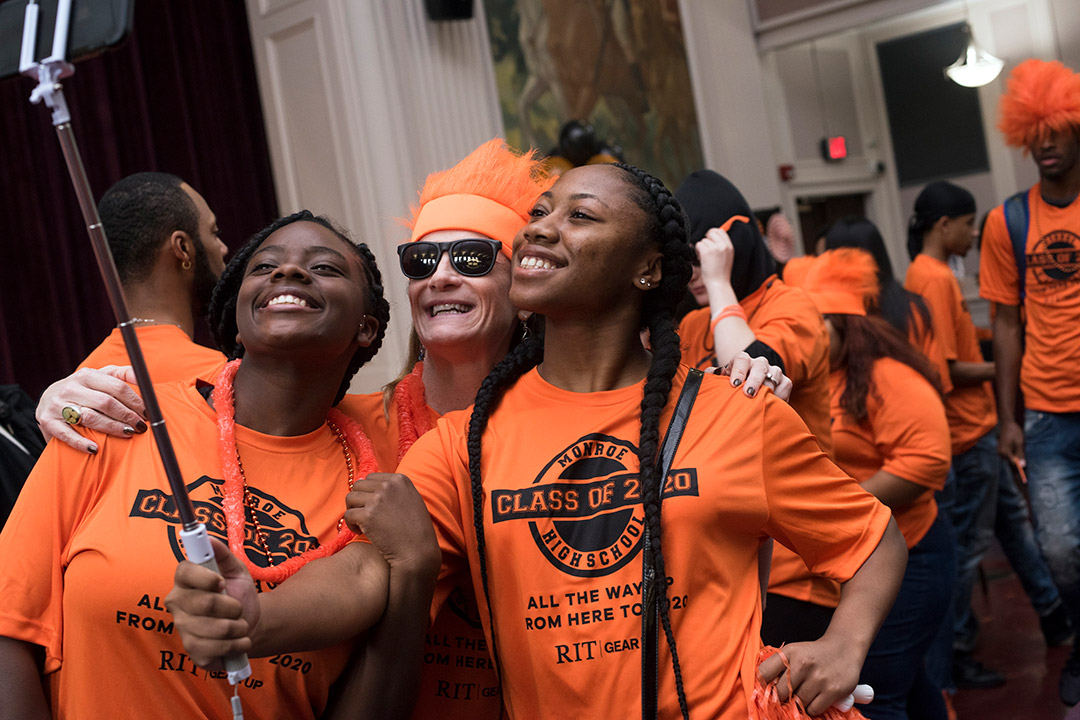 High school students take selfie with principal.