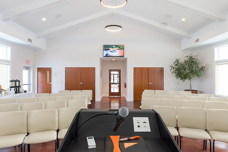 'view from podium of rows of empty seats in conference room.'