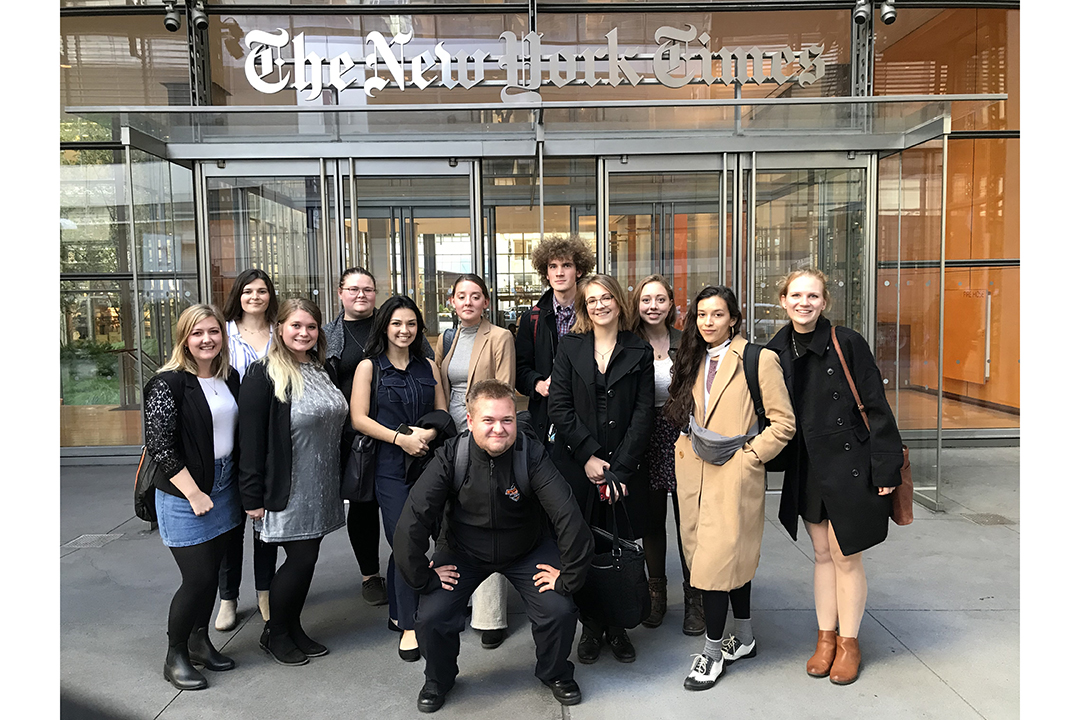 Students gather for a group photo in front of The New York Times.