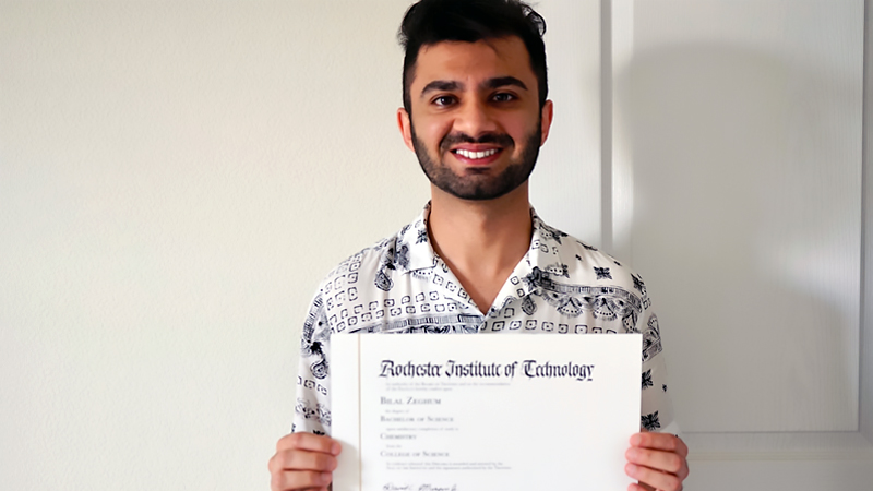 student holding a degree