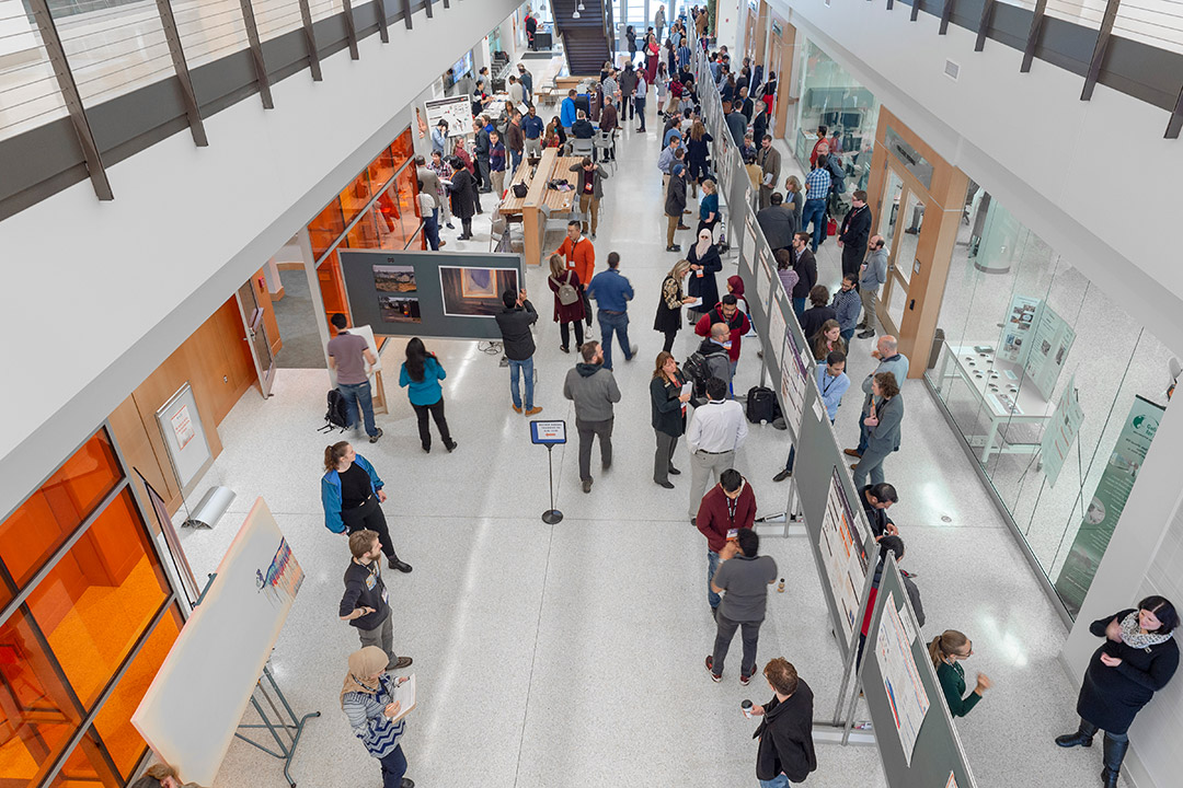 overhead view of people looking at poster presentations.