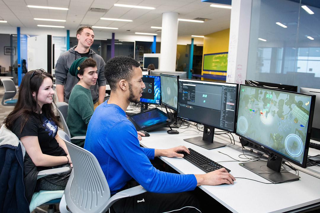 students on computers at a desk.