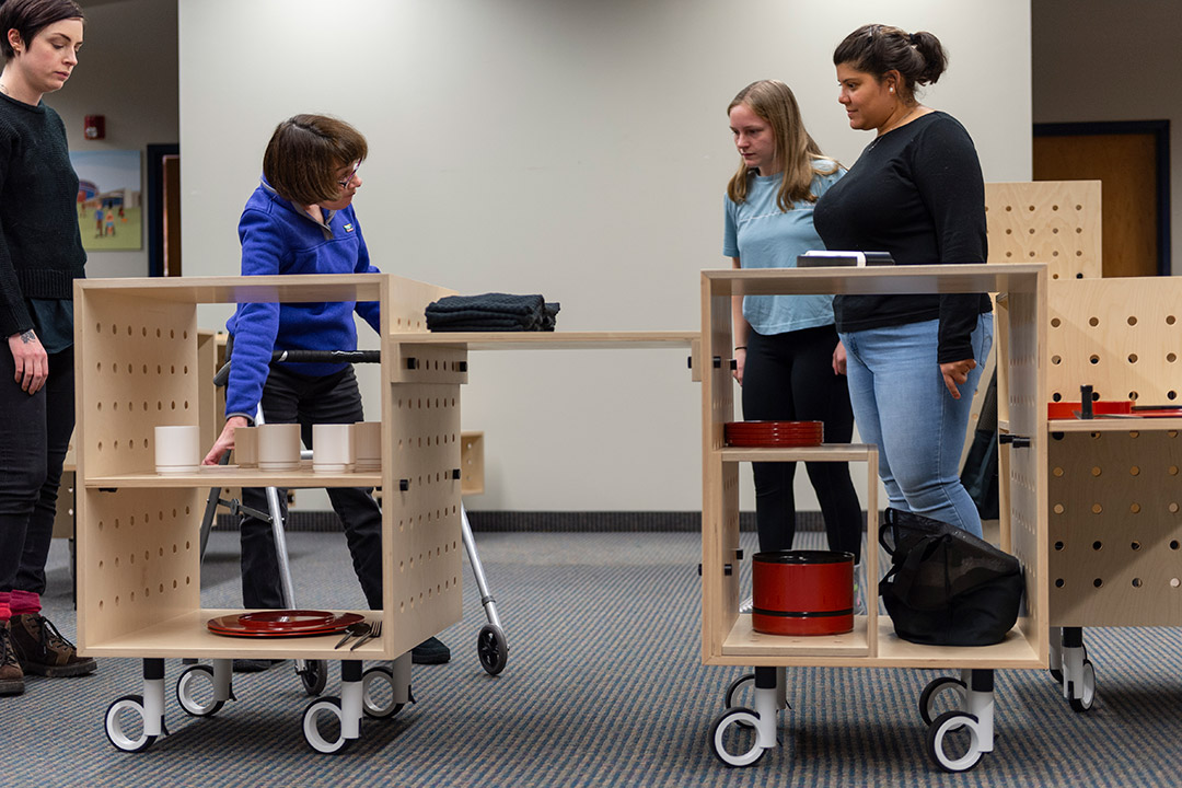 students demonstrating mobile kitchen project.