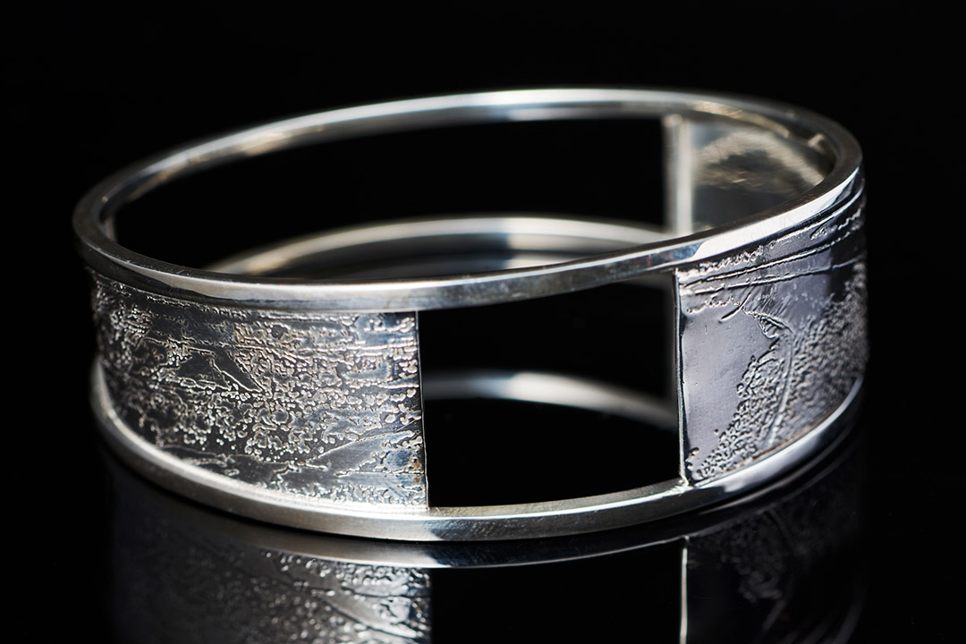 silver cuff-style bracelet.