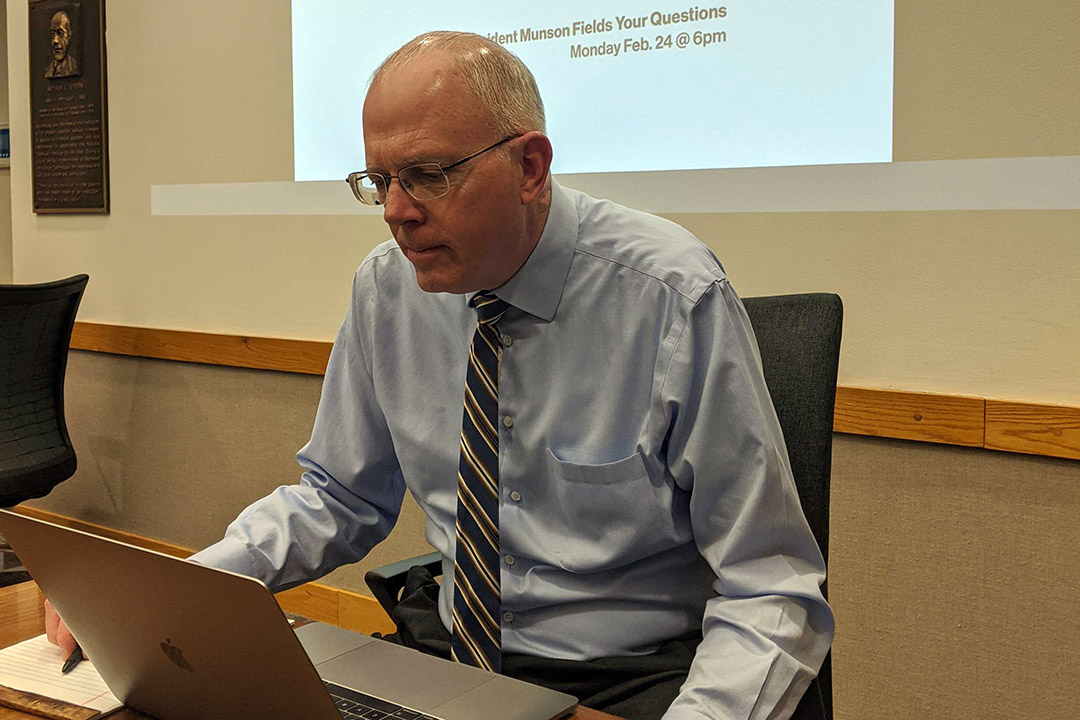 President Munson working on a laptop computer.