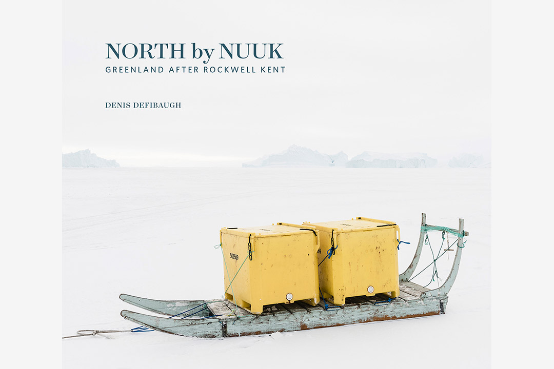 'North by Nuuk' book cover, featuring two yellow boxs on wooden sled on a sheet of ice.