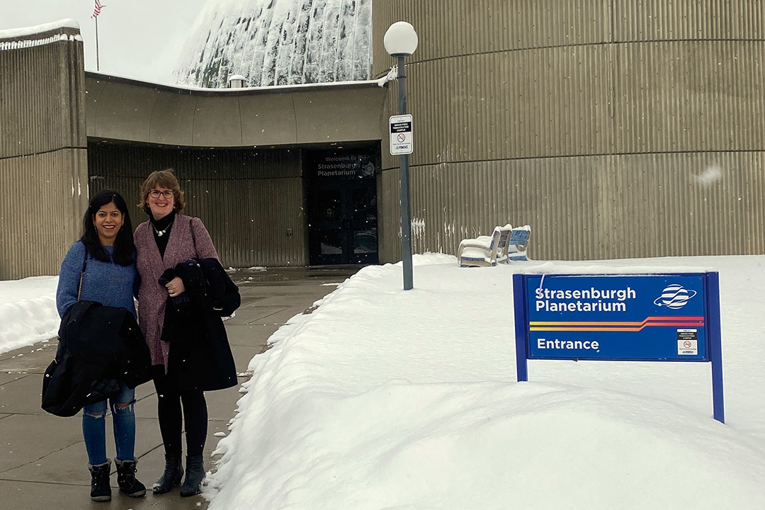 two people standing outside the planetarium.