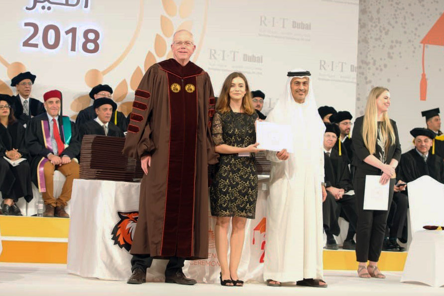 university officials standing with student at graduation eremony in RIT Dubai.