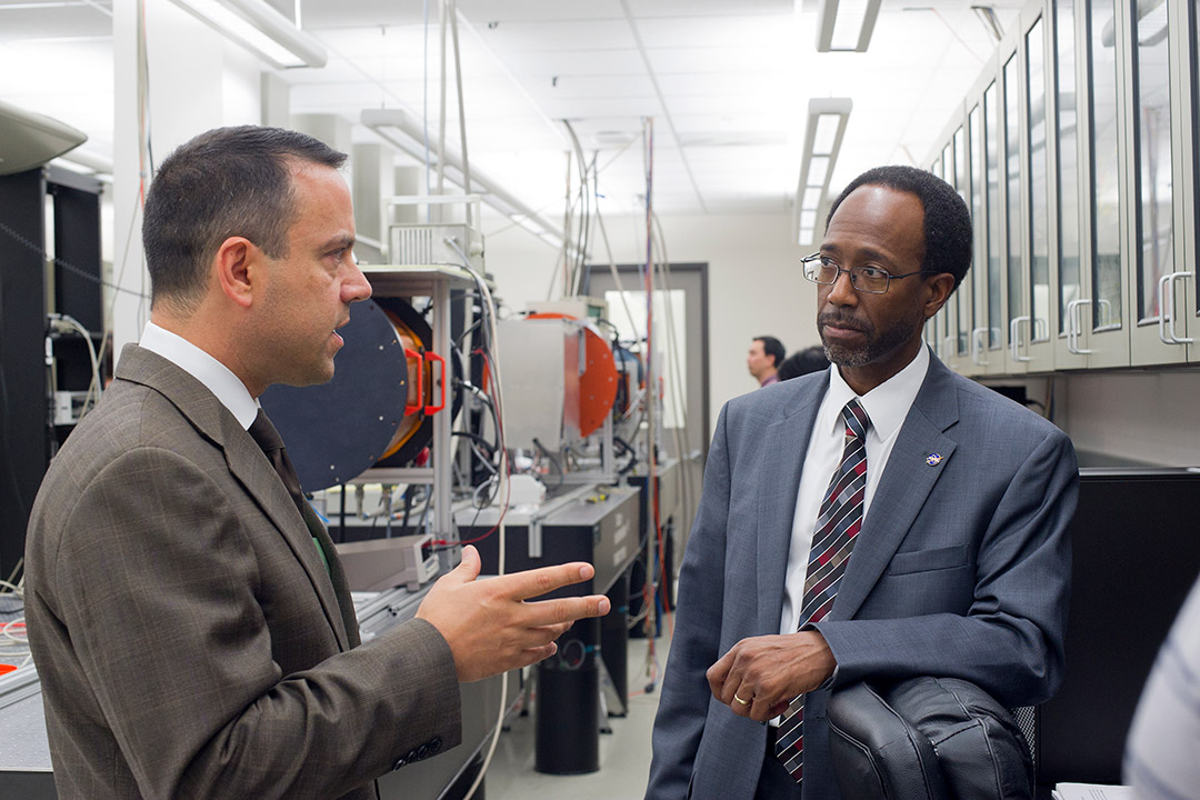 two men talking in lab.