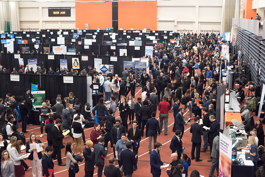 crowd of people attending a career fair.