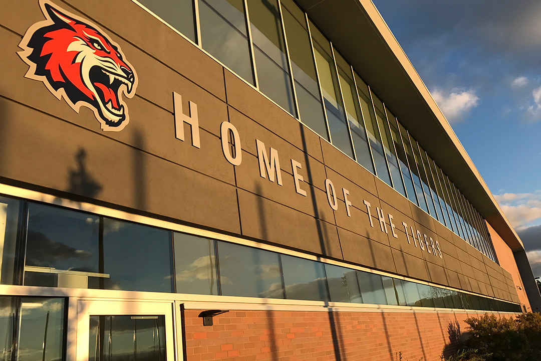 exterior of Gene Polisseni Center with banner that reads: Home of the Tigers.