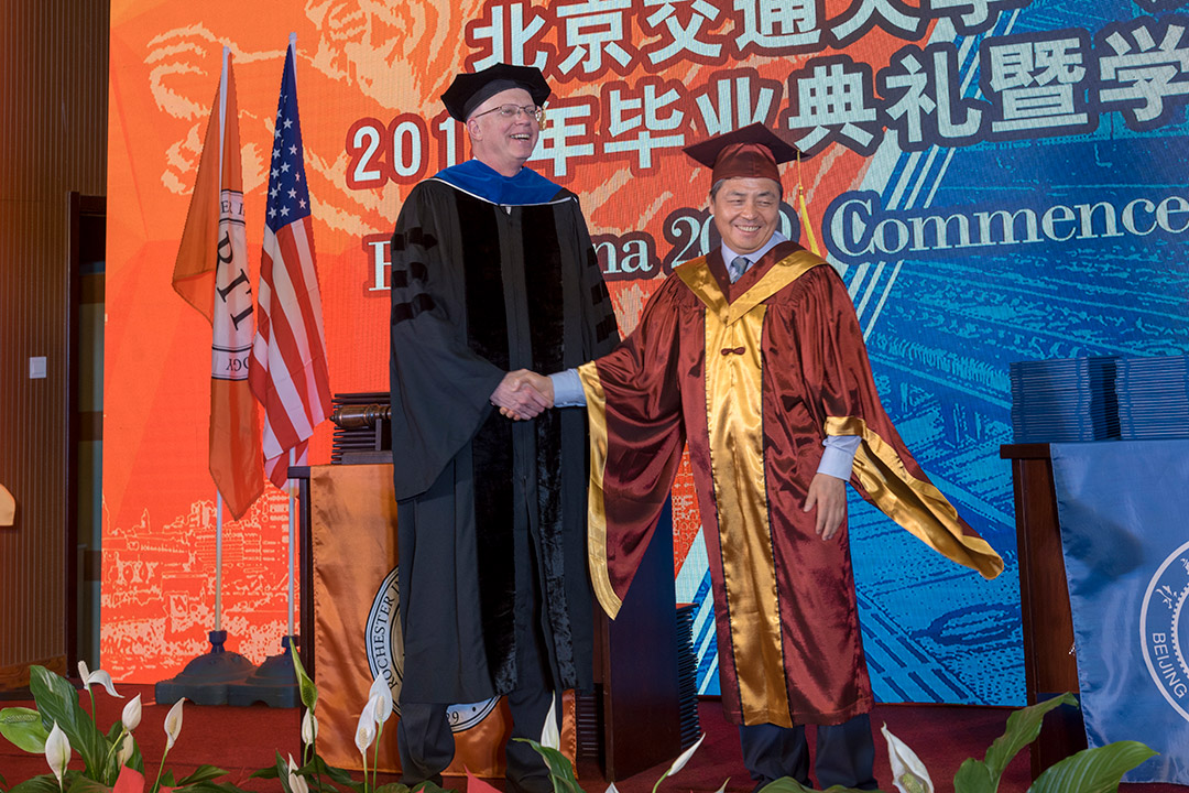 Presidents of RIT and Beijing Jiaotong University Weihai shaking hands.