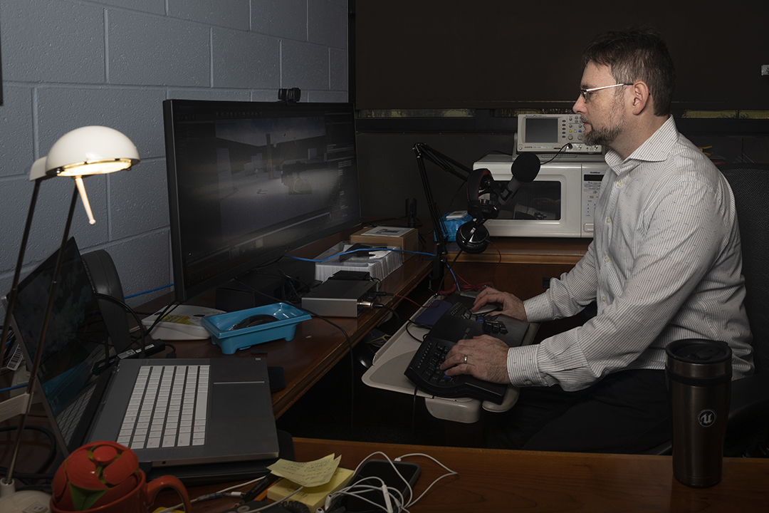 Faculty Shaun Foster works on the computer in his office.