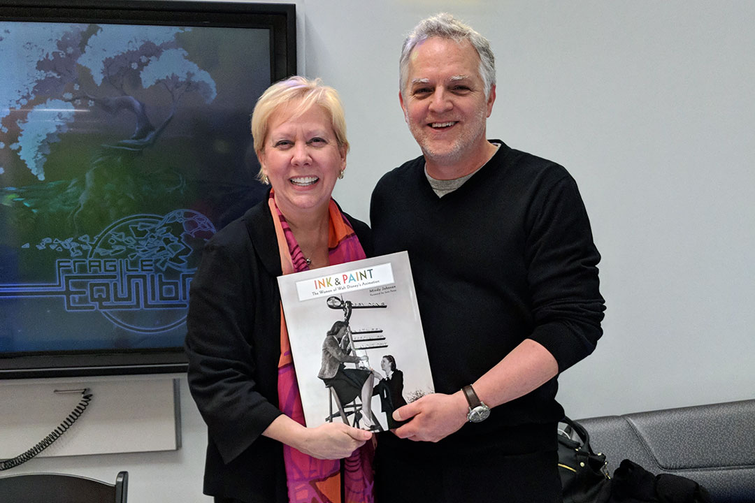 two people holding book called Ink and Paint.