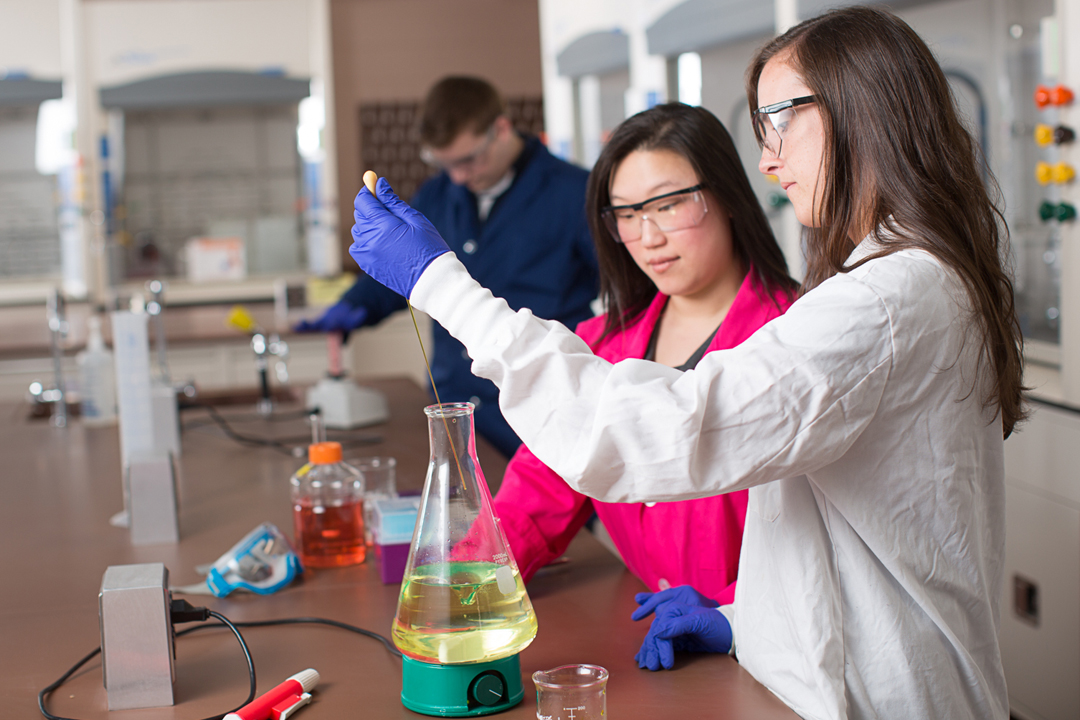 biochemistry student working in lab with professor