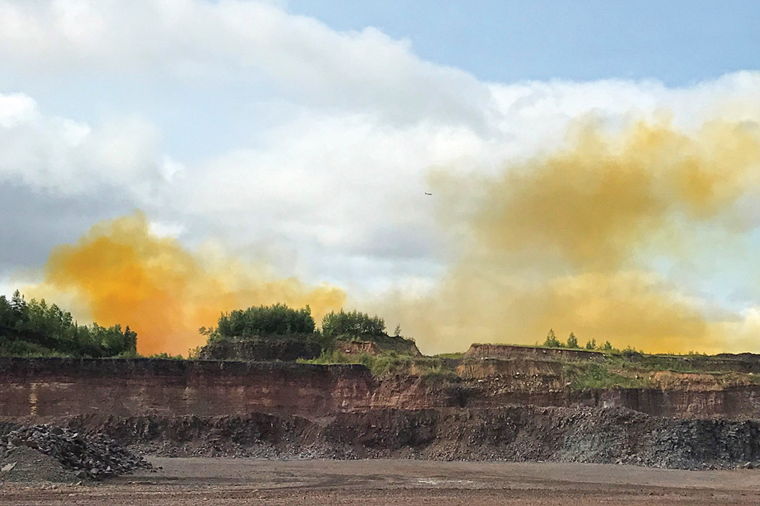 blast zone with yellow-orange gas in the background.