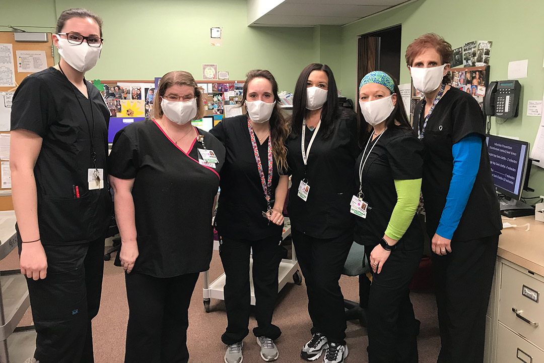 group of nurses wearing facemasks.