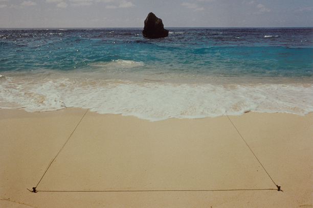 A photo of a rock structure in the ocean. 