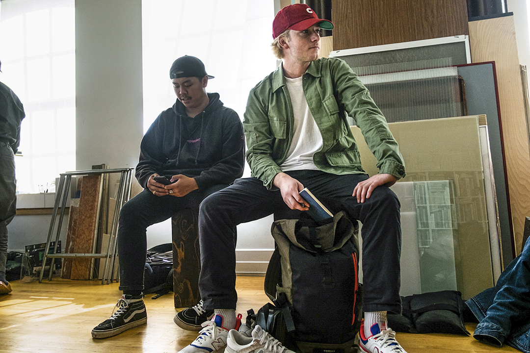 Will Moran sits on a stool in a studio on the photo school's annual trip to New York City.