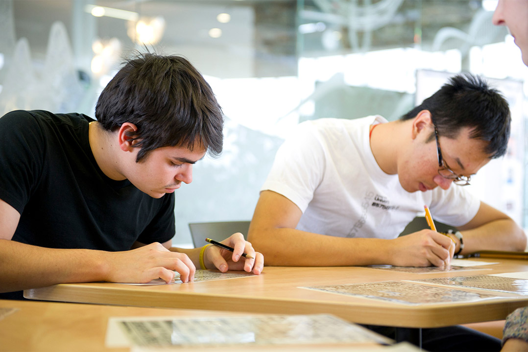 two students filling out a worksheet.