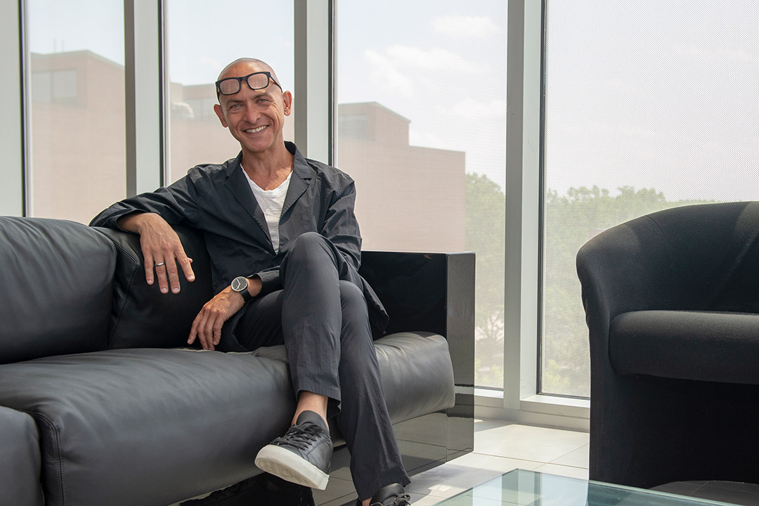 Professor Josh Owens sitting on sofa.