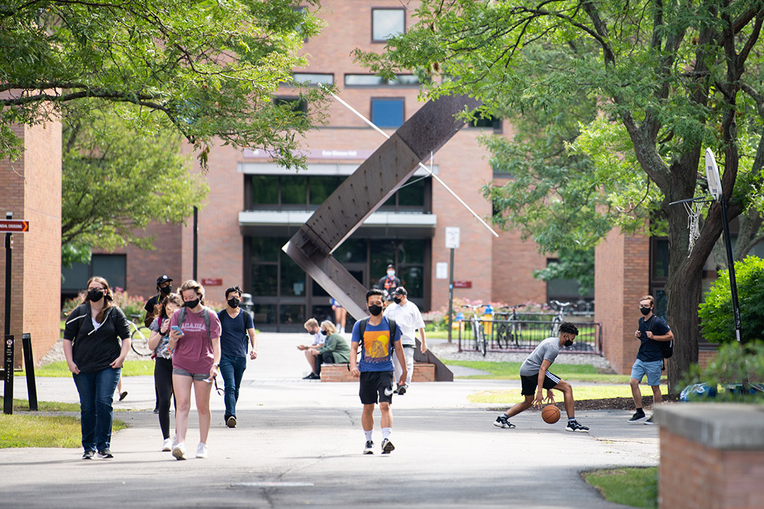 students wearing masks while walking outside.